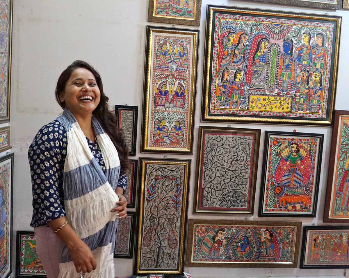 Thakur stands in her Janakpur studio, surrounded by paintings that she and her students created. She's been training Mithila artists here since 2008.