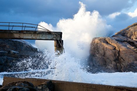 Waves crash against the abandoned plant.