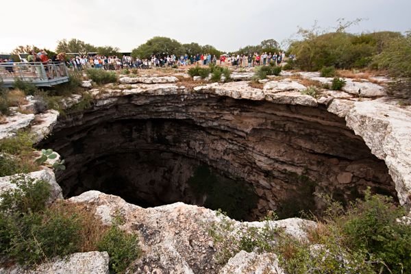 A crowd gathered to watch bats emerge from the Devil’s sinkhole.