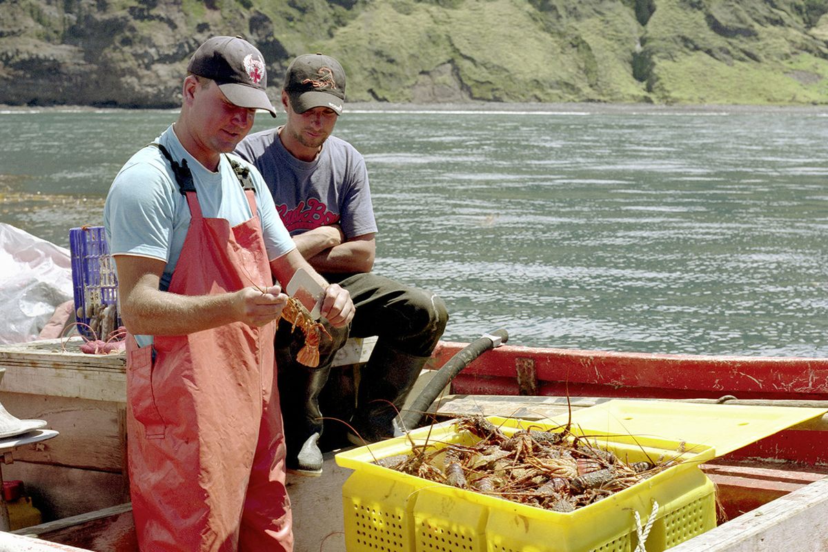Two islanders with a catch of crawfish.