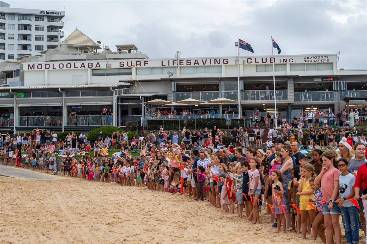 Children on Mooloolaba beach await Santa's Christmas Eve arrival.