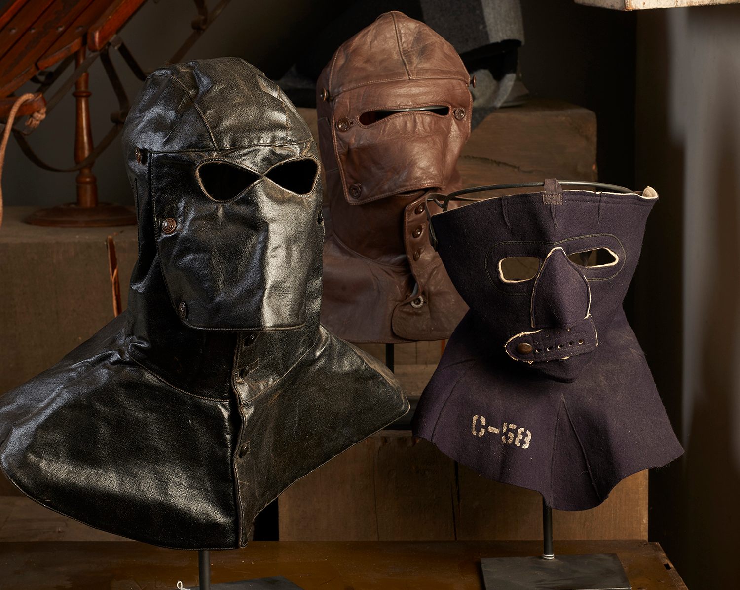 Masks for extreme cold weather. From left, a WWII submarine loader's hood, a Russian motorcycle mask and a WWII US Air Force flight mask.