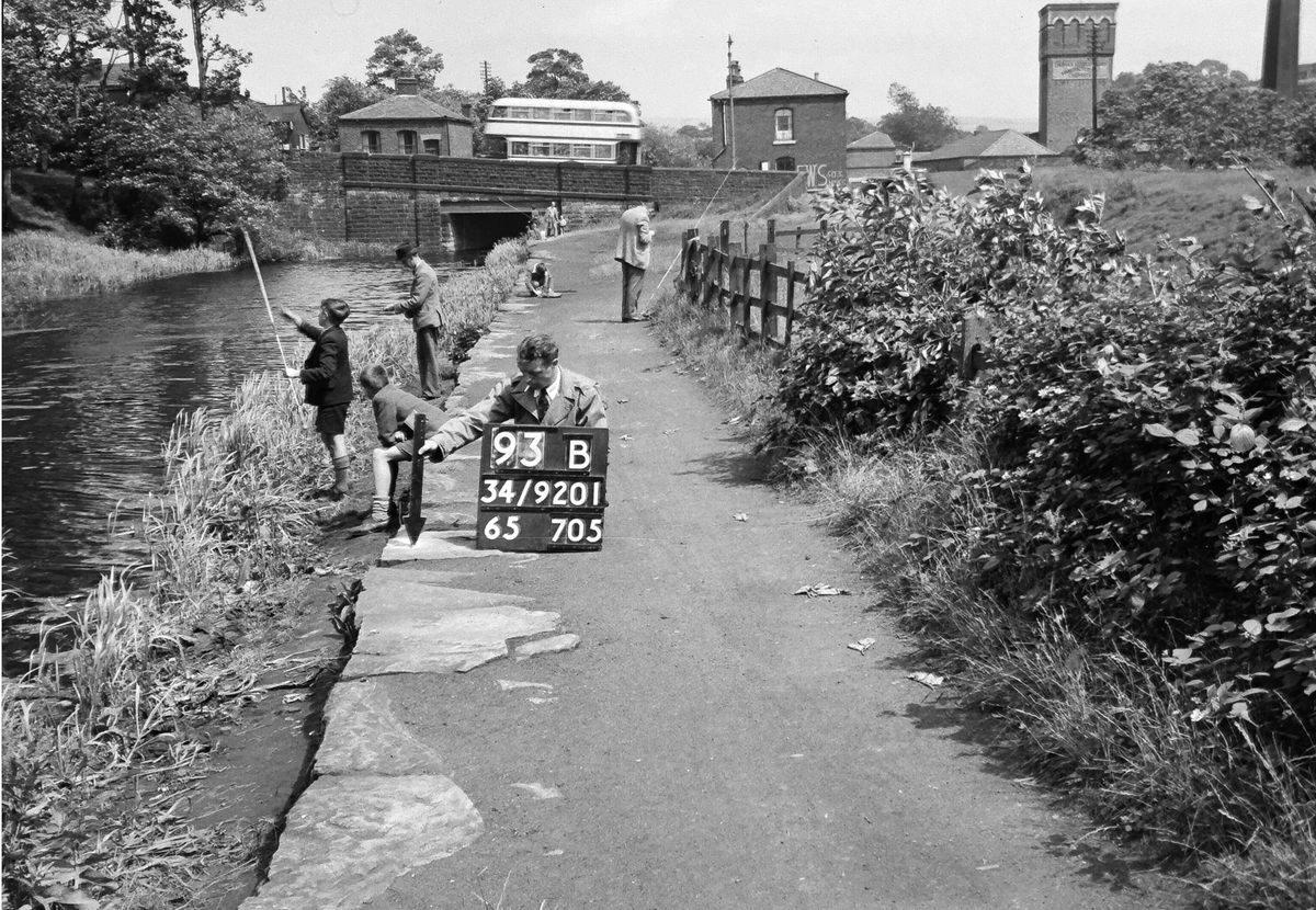 A survey worker, tied to his job as kids have fun around him.