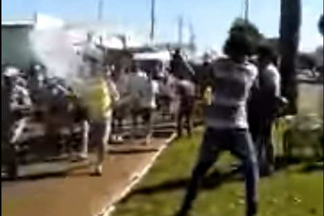 Watch a Man Throw a Bucket of Water at the Olympic Torch and Miss