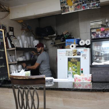 The food is arranged on steam tables behind the counter.