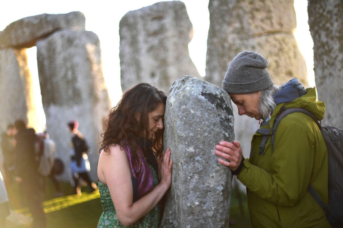 Visitors celebrate the dawn of the summer solstice—the longest day of the year—at Stonehenge in 2019.