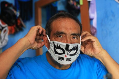 Isaías Huerta, a retired lucha libre wrestler, showing one of his face masks in Puebla, Mexico, April 23, 2020.