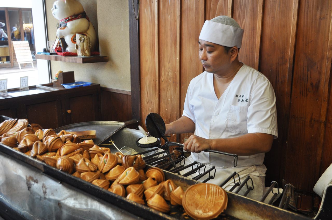 A baker makes fortune cookies at Hougyokudo in Kyoto, Japan.