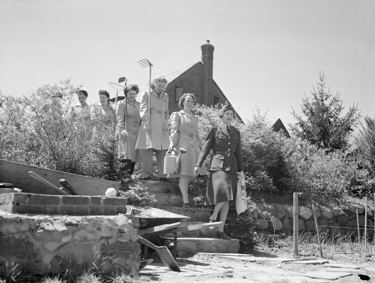 Members of a women's volunteer service in Flushing march into their Victory Garden.
