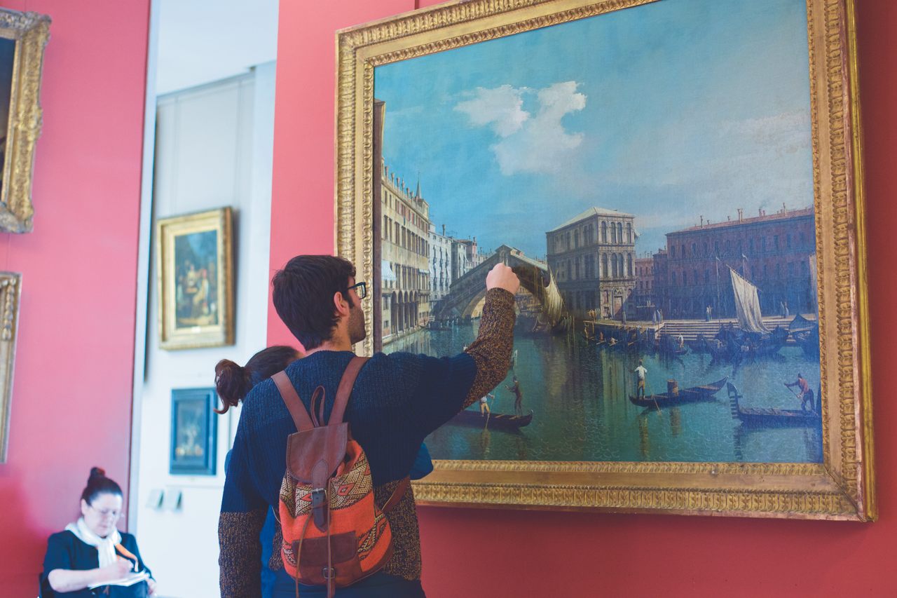 A visitor to the Louvre is tempted by Canaletto's 18th-century painting "The Rialto Bridge in Venice."