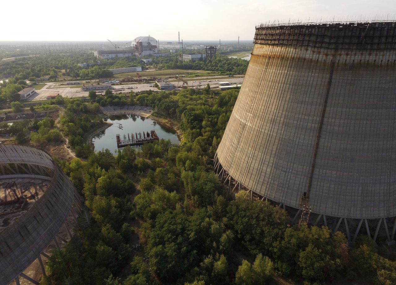 Partially built and abandoned cooling towers at Chernobyl, with the "sarcophagus" in the distance, 2017. 
