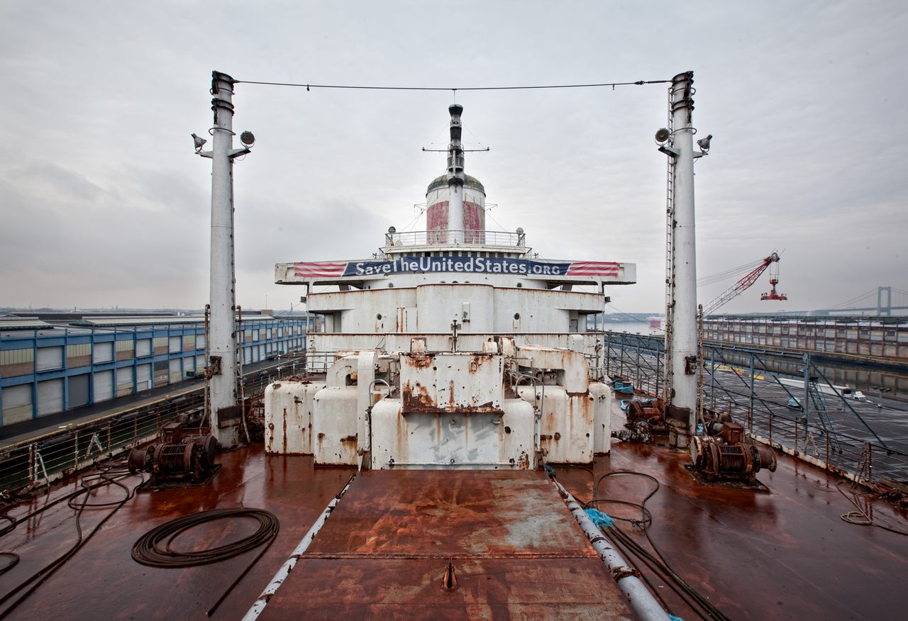 The deck of the SS United States, with a sign directing to the SS United States Conservancy's website.