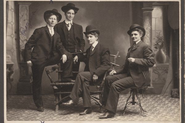 This photo, taken on the Minnesota frontier, depicts Regina Sorenson and three others "dressed in men's suits."