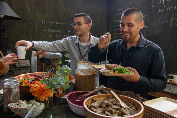 Louis Trevino (left) and Vincent Medina (right) plate traditional food at Cafe Ohlone.