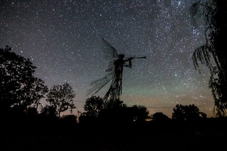 The angel backdropped by a sea of stars.