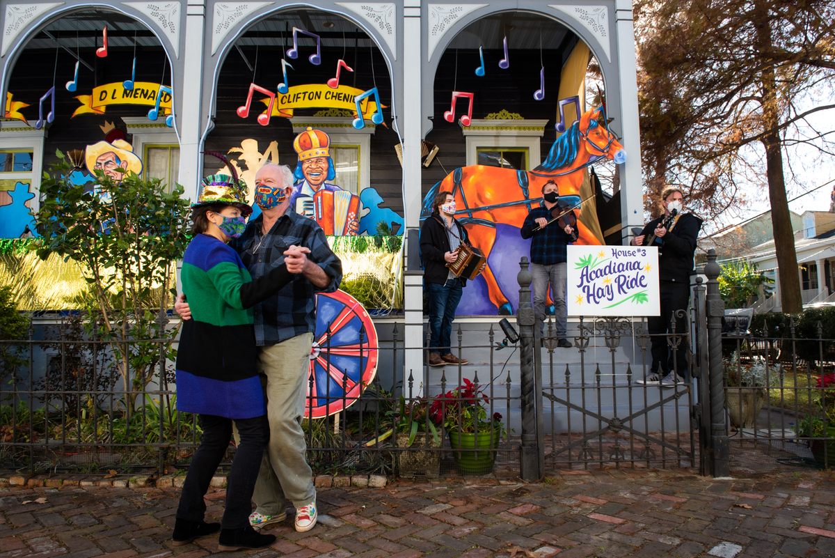 Stacey and Mike Burke dance to the Michot's Melody Makers during the reveal of their house float, "Acadiana Hay Ride."