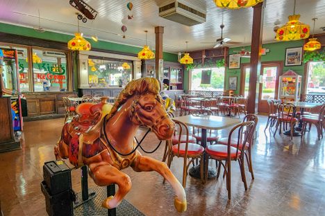 A coin=operated rocking horse sits ready and waiting in the dining room of Kirk’s 61st Avenue location. 