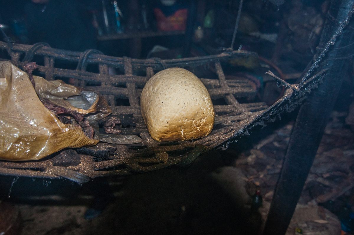 This yak cheese above the fire will dry, harden, and take on a nice, smoky flavor.