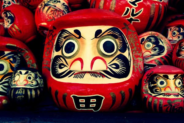 A large daruma rests easy having fulfilled its purpose 