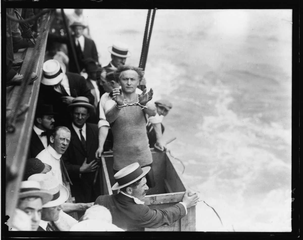 Harry Houdini prepares to jump into New York's East River in handcuffs.