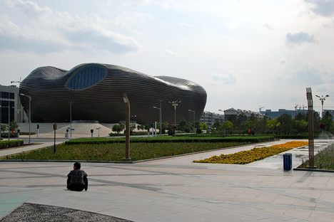 A lone man sits near the museum in Kangbashi.