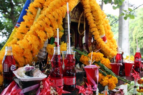 Gods and spirits are offered flowers, food, and Fanta.
