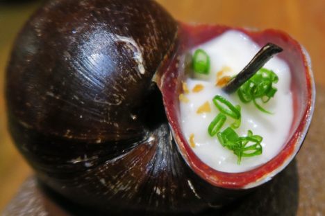 A churo snail simmered in soy with dale dale root foam at Maido, a restaurant in Lima.