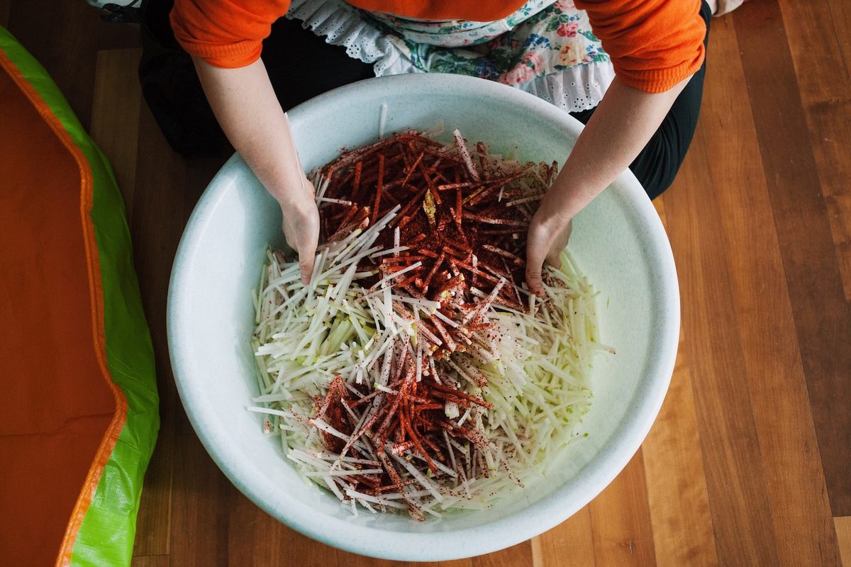 Lee seasons the cut daikon with red pepper flakes and salt.