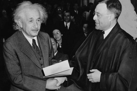Albert Einstein accepting American citizenship from Judge Philip Forman in 1940. 