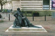 The side of the statue, as he faces Guildhall Square