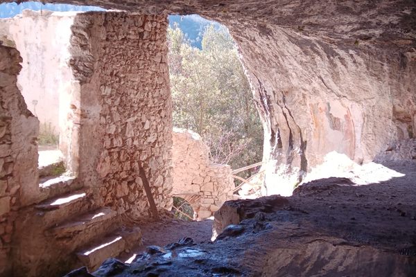 The hermit's house seen from inside the cave with the well on the lower left