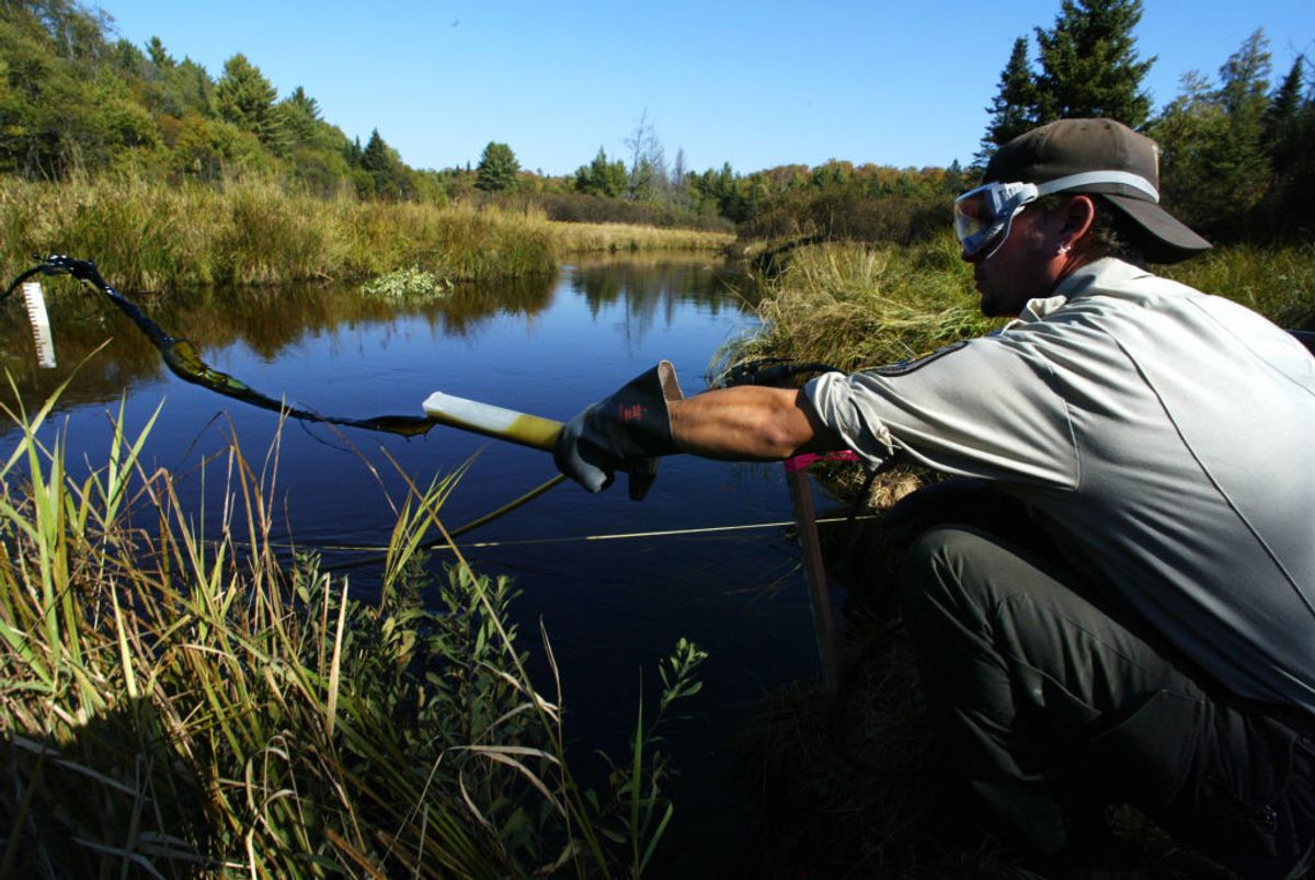 Dave Magne, a technician with the U.S. Fish and Wildlife Service checking on lampricide levels in Manistique River, Michigan.