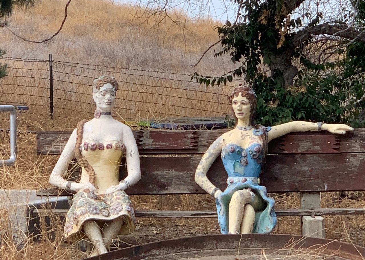 For artist John Enh's family, many of the statues that make up Old Trapper's Lodge, like these two women sitting on the campus of Pierce College, are tributes to lost loved ones. 