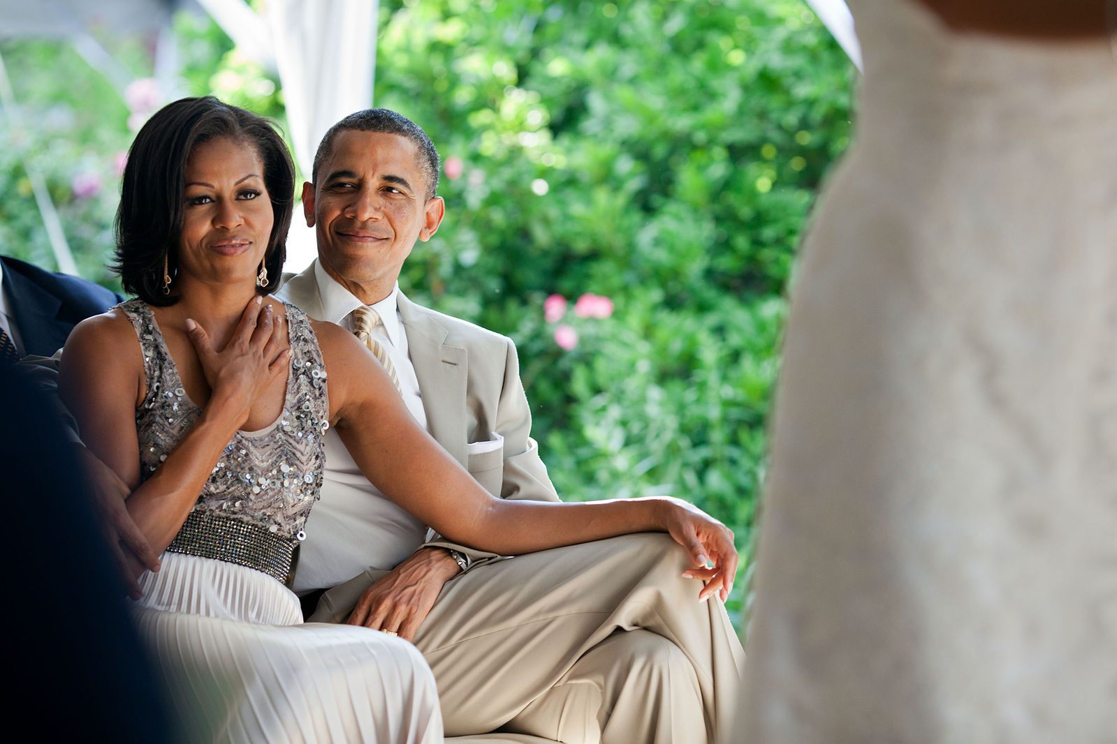 The Obamas, demonstrating their love for weddings, in 2012.