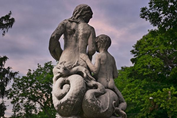 Rear view of the two figures atop the Annie Stewart Memorial Fountain located near the effigy mounds at the end of Erin Street overlooking the Henry Vilas Zoo in Madison, Wisconsin