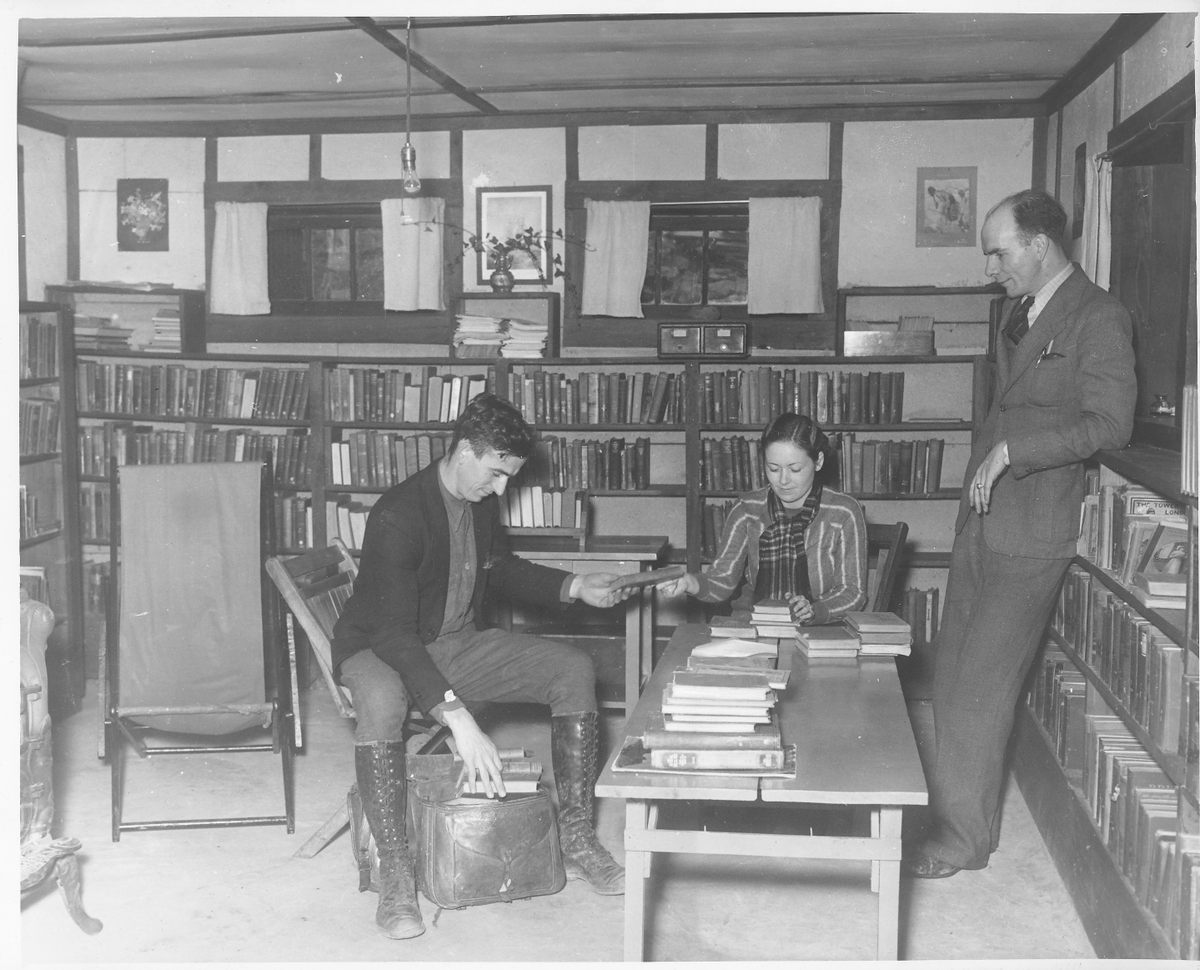 Packing saddle bags with books, date unknown.