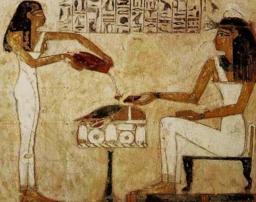Egyptian hieroglyphics depict women pouring beer.