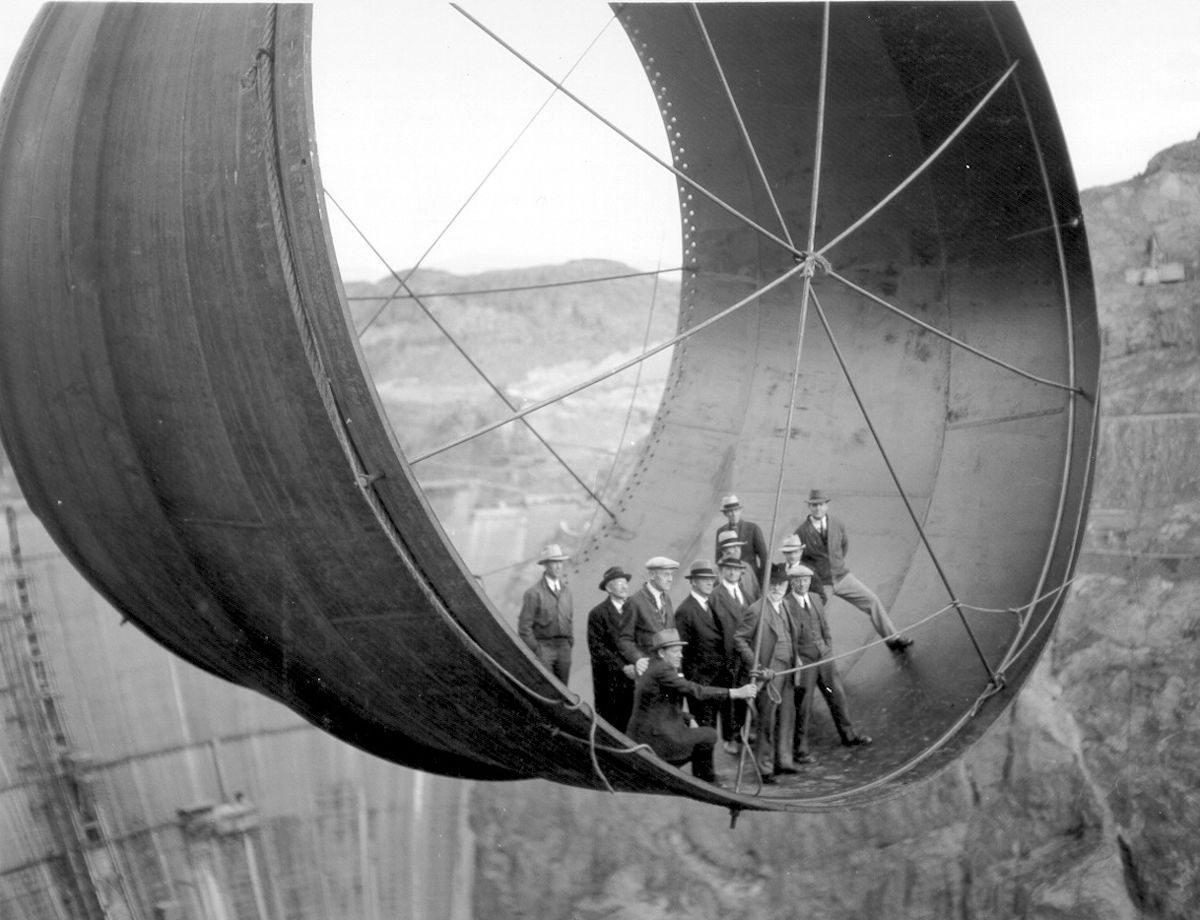 Members of the Boulder City Consulting Board and other officials standing in a section of pipe over the Hoover Dam, 1935.
