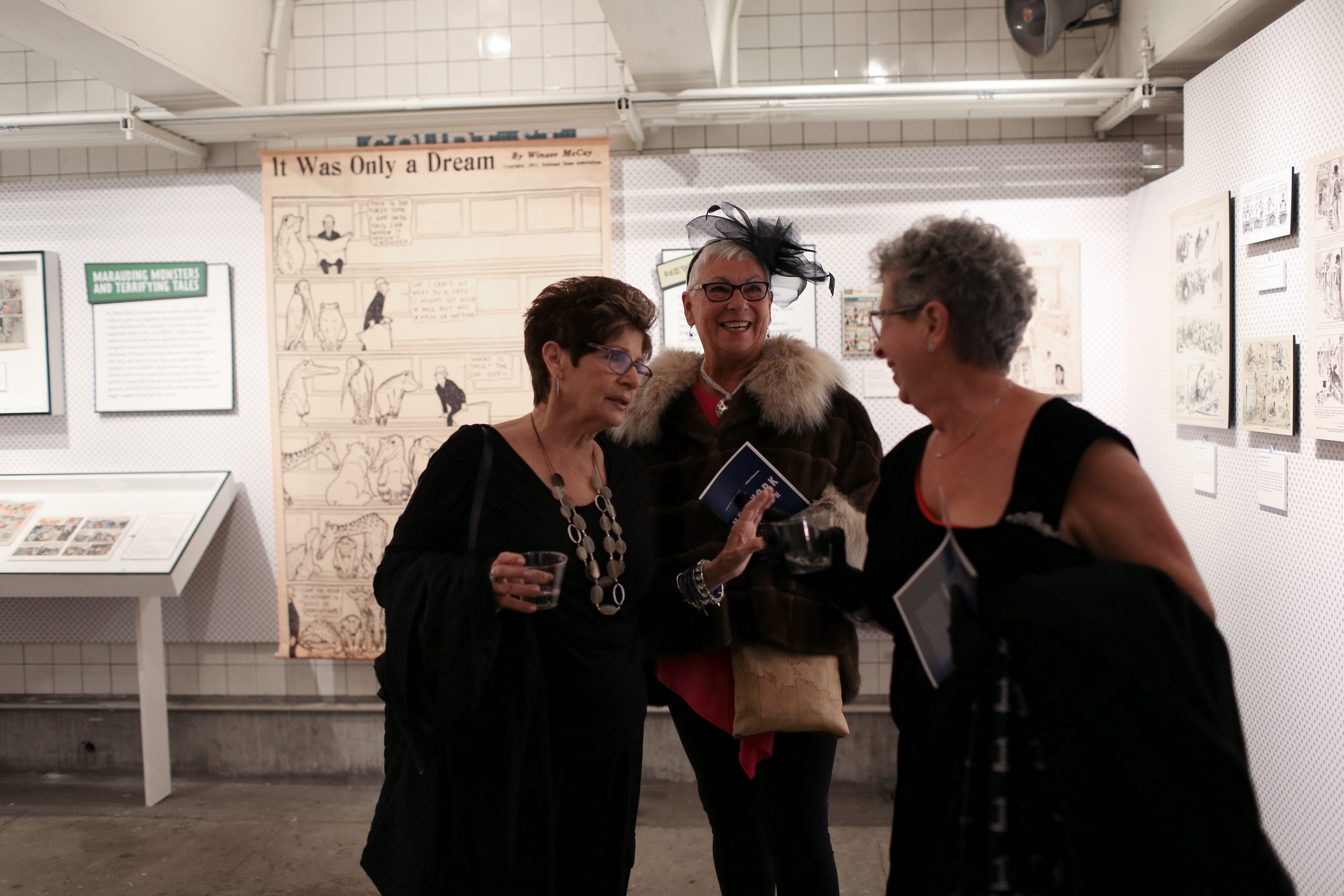 A group of friends congregates among the Transit Museum's exhibits. 