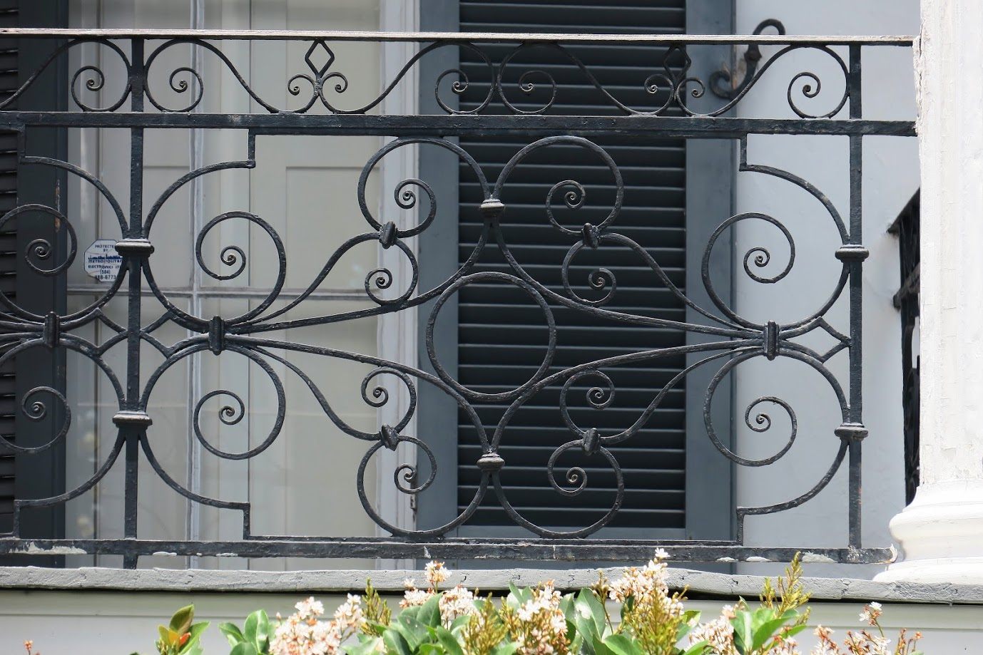 An Adinkra symbol is woven into the balcony at 521 Dauphine Street. "Dwennimmen," or "ram's horns," stands for strength combined with humility.