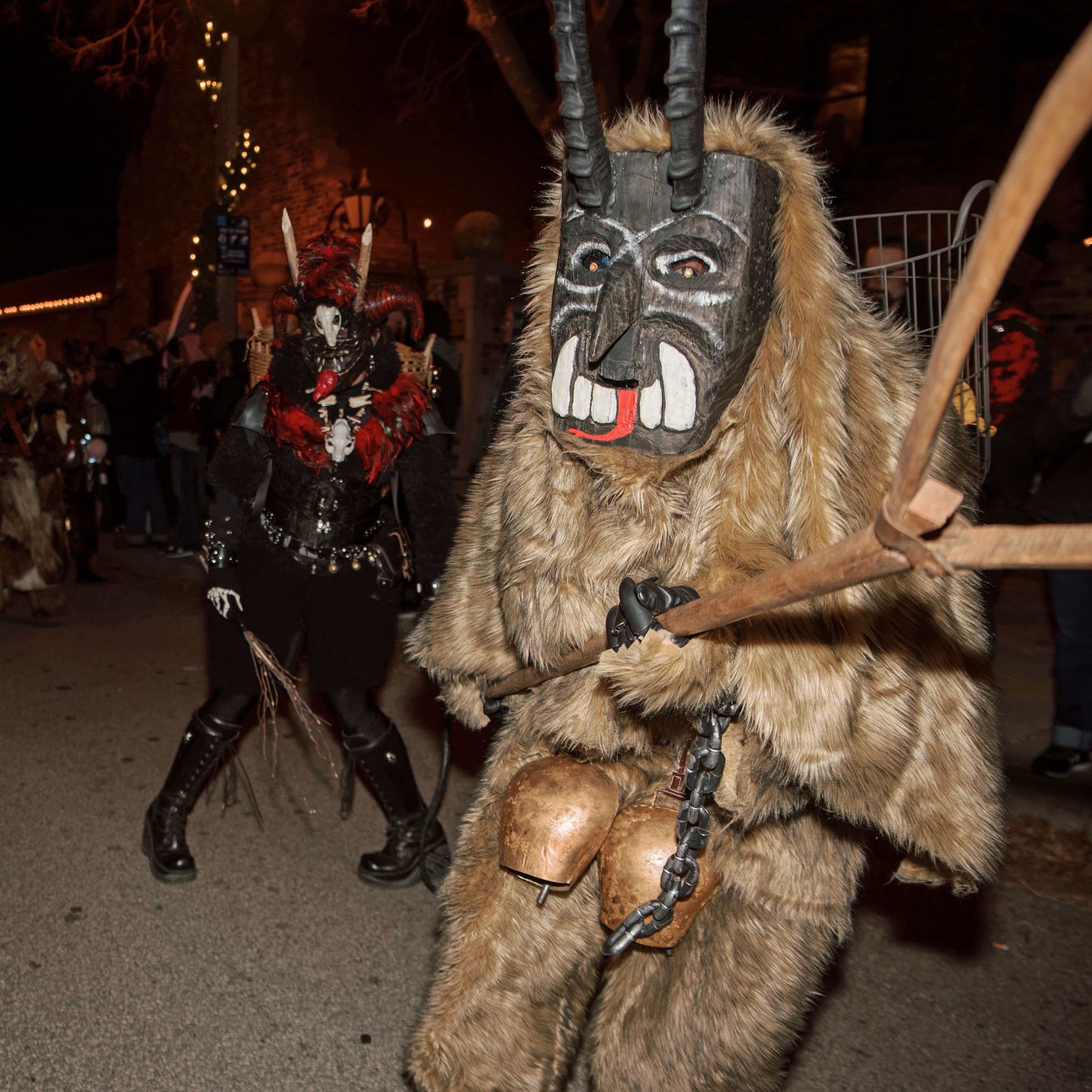 A member of the Milwaukee Krampus Eigenheit (foreground) sports a heavy, two-foot-long wooden mask similar to some of the styles worn in the Alpine birthplace of the tradition.