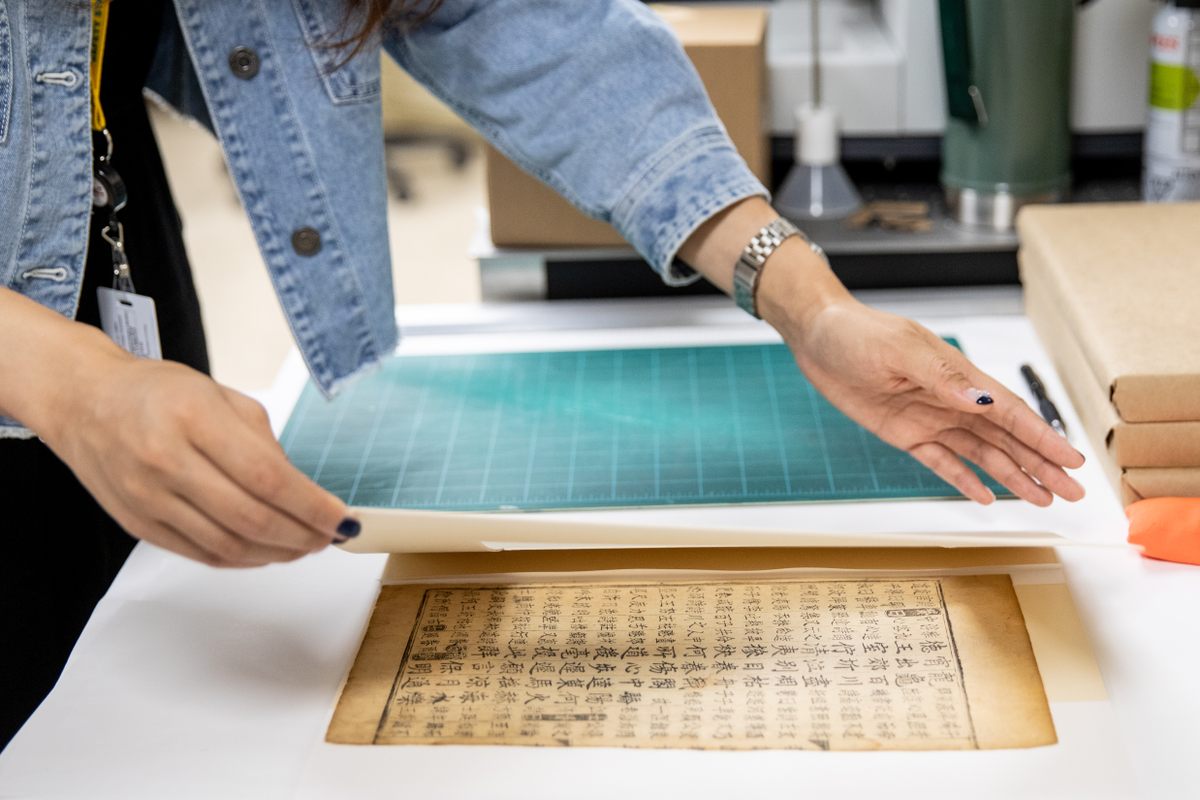 UNESCO's Angelica Noh prepares a document from 15th century Korea to be scanned on the synchrotron.