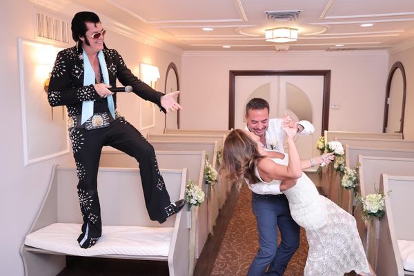 An Elvis impersonator officiates a wedding at Graceland Wedding Chapel in Las Vegas.