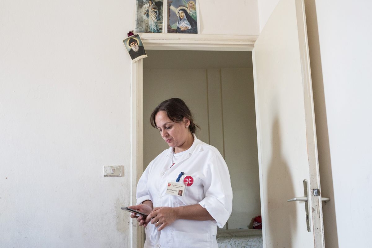 Order of Malta nurse Souad Farchakh visits an Iraqi family who fled Qaraqoush after it was invaded by ISIS, in the apartment they now rent in Zgharta, Lebanon.
