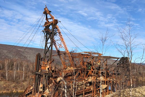 The wood and tin portions of the dredge were consumed by the fire. Only the ghostly steel structure remains.