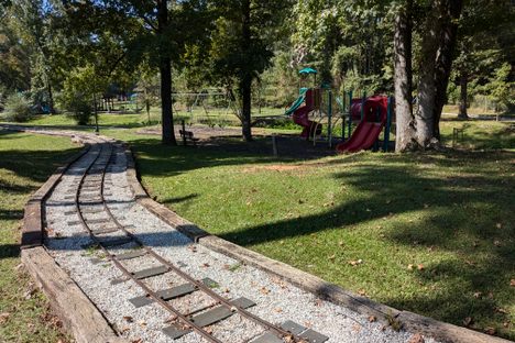 Miniature railroad tracks and playground equipment.
