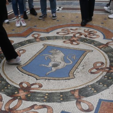 The Dancing Bull is found in front of Dior and Swarovski stores, the left turn from the main entrance looking to Duomo.