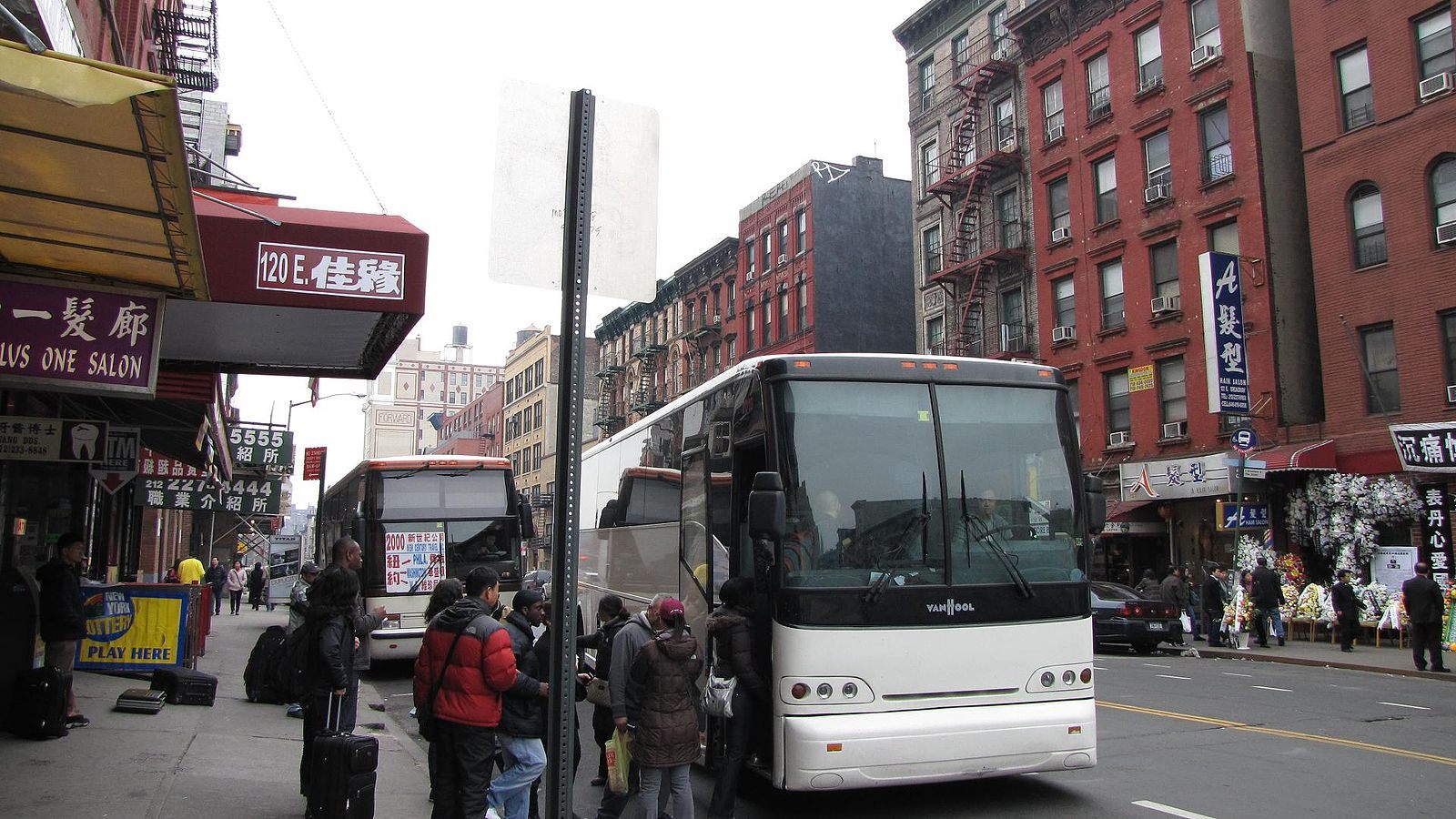 Passengers wait to get on a Chinatown bus in Manhattan.