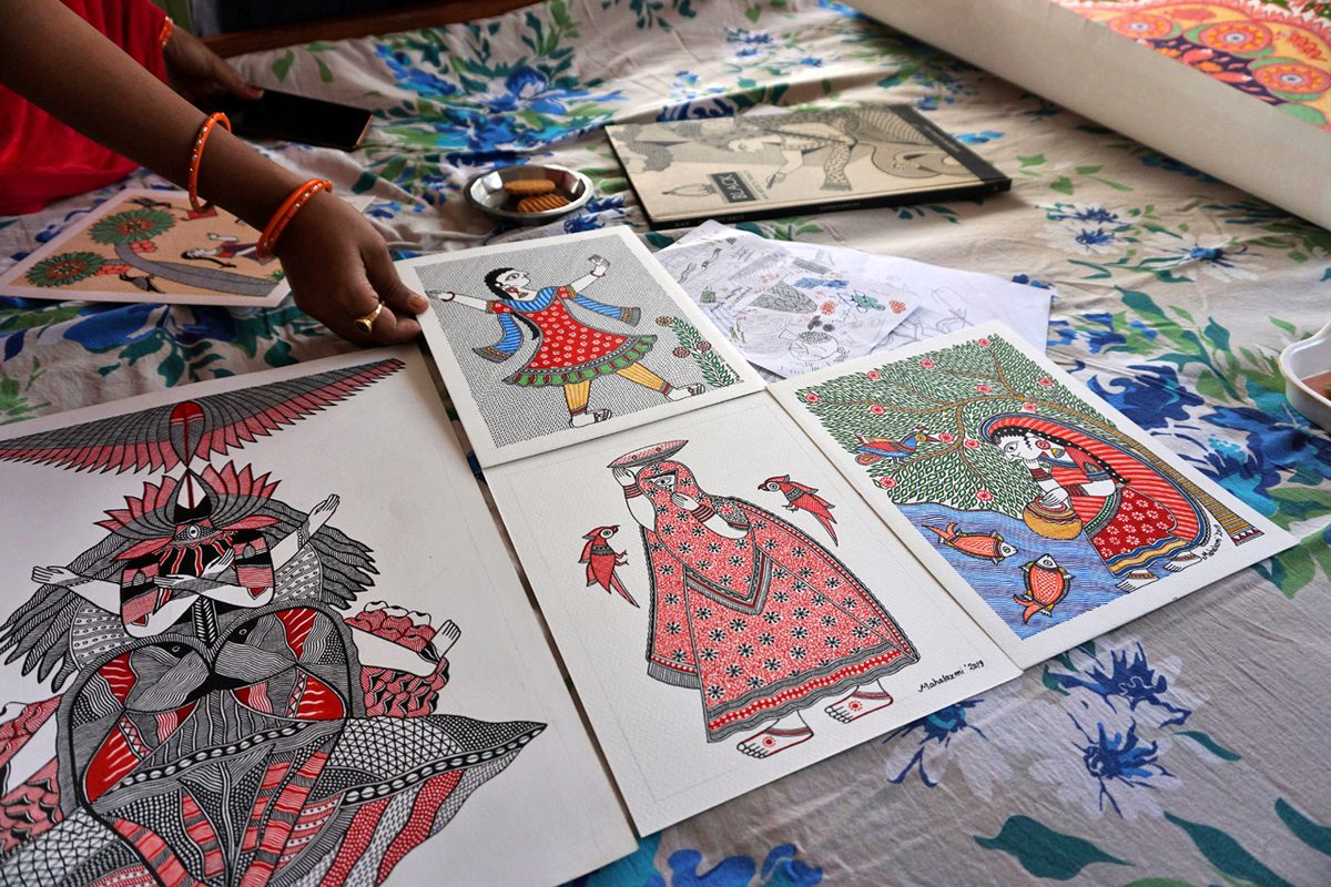 Mononymous artist Mahalaxmi shows some of her Mithila paintings inside her home in Ranti, a small village in Bihar, India.