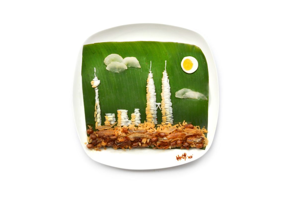 The Kuala Lumpur skyline made from Malaysia's national dish: nasi lemak (cucumber slices, anchovies, roasted peanuts, egg, rice, coconut cream, and sambal wrapped in a banana leaf).